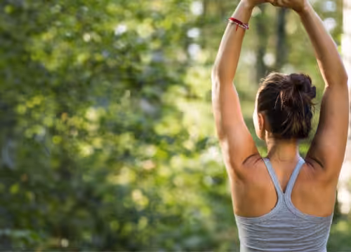Woman stretching in a field