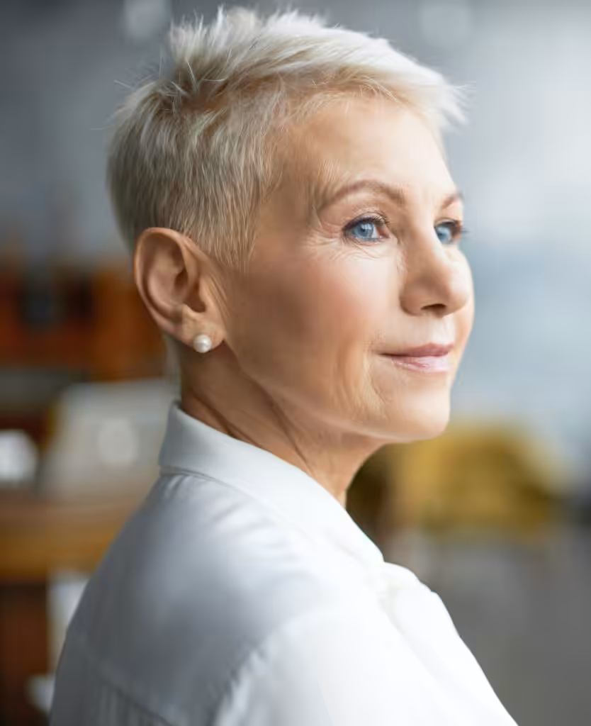 Older woman with short hair and a white top