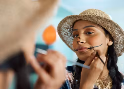 Photo of a woman applying Halloween makeup